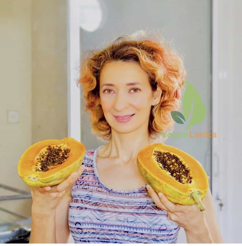Inga holding a papaya in sri lanka