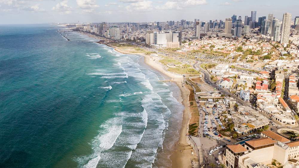 Aerial view of the big city with sandy seashore and wavy sea, tel aviv, israel