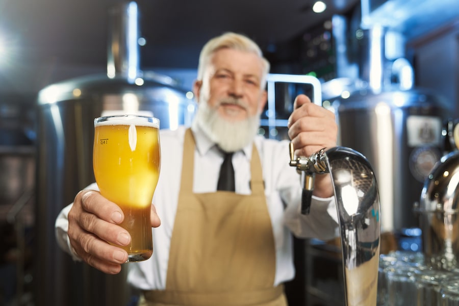 Elderly barman holding cold glass with lager beer 2022 01 18 23 33 29 utc