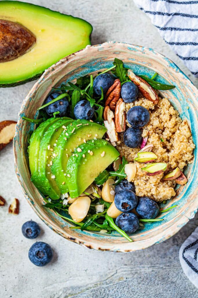 Vegan quinoa salad with berries, avocados and nuts. Healthy, vegan keto diet