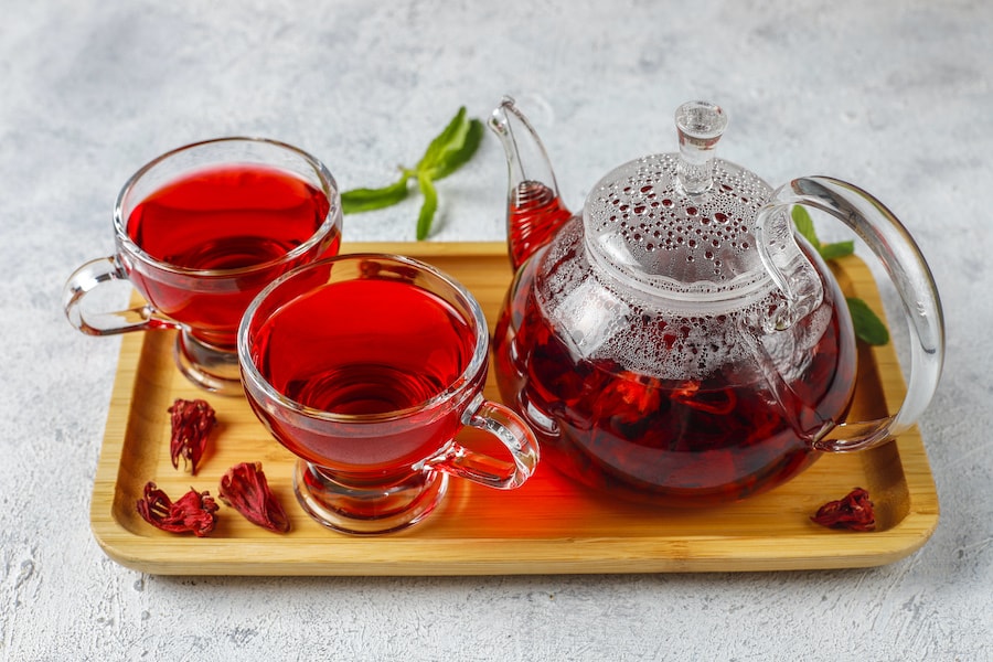 Hot hibiscus tea in a glass mug and glass teapot 2022 01 21 17 21 31 utc