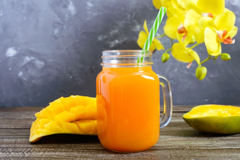 Mango smoothie in a glass jar and fresh mango 2021 08 31 11 18 19 utc